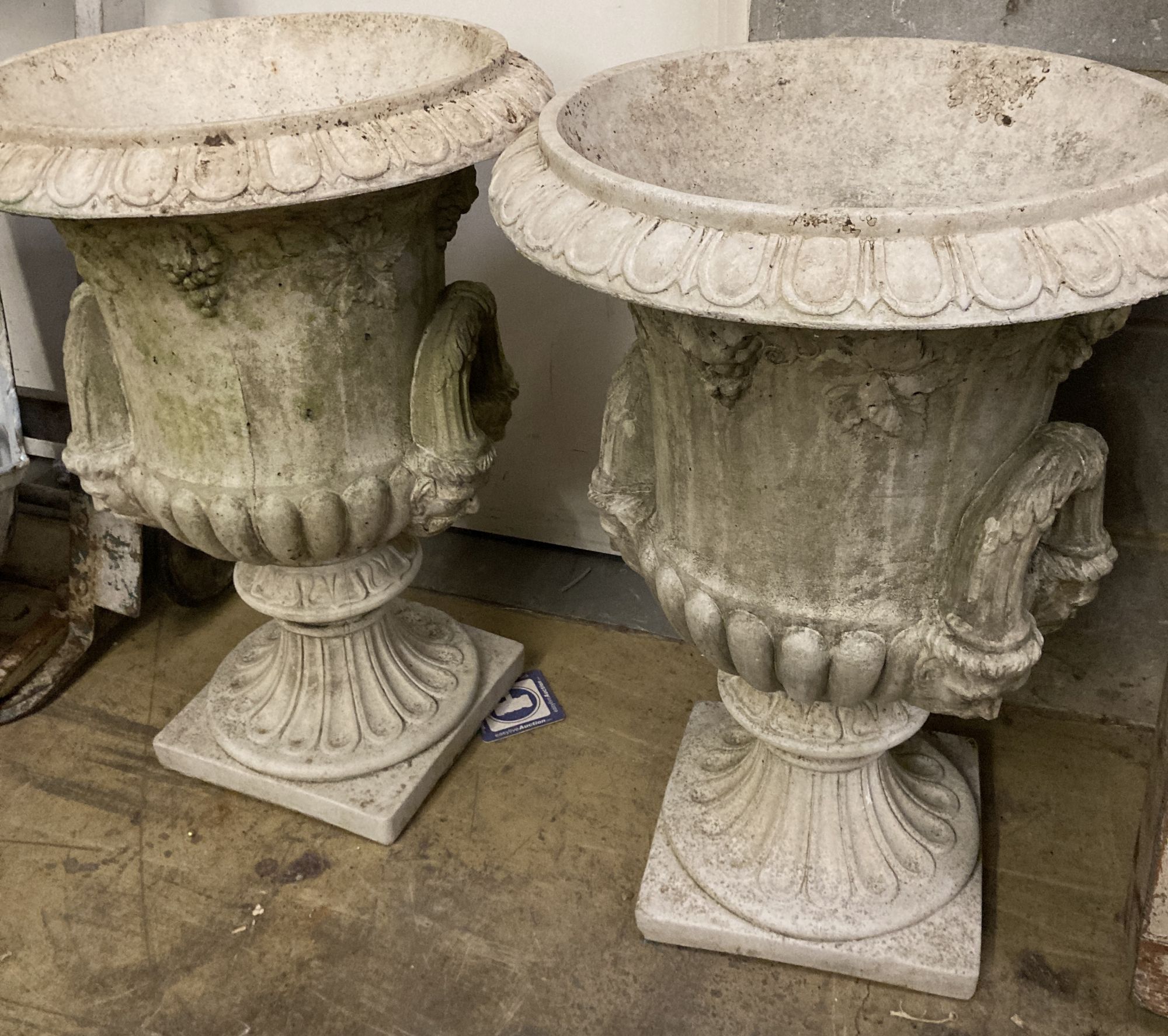 A pair of reconstituted stone campana shaped garden urns, diameter 54cm, height 72cm